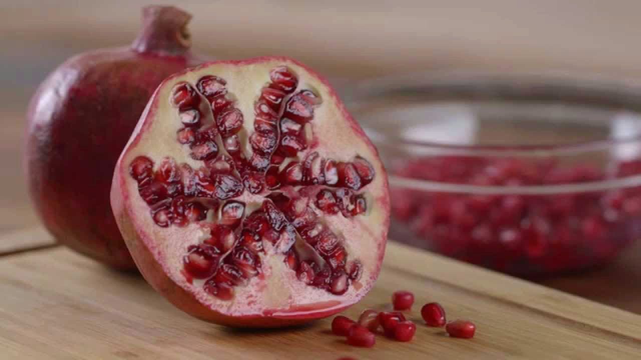 Pomegranate cut open showing seeds for preparation